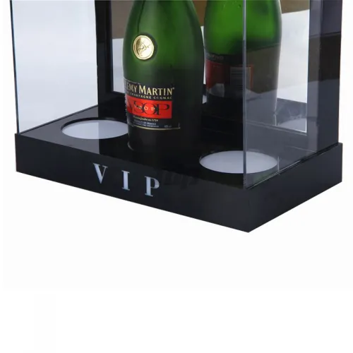 close-up of VIP wine display stand - emerald green Remy Martin bottle showcase with illuminated acrylic case