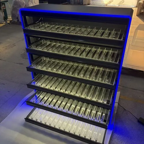 cigarette display with automatic lighting and shelf pushers