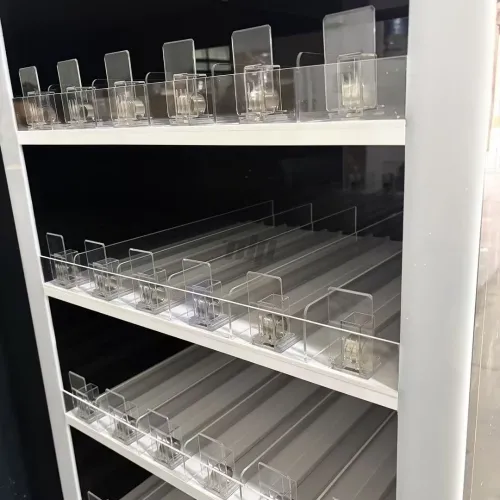 cigarette display shelf with integrated pushers